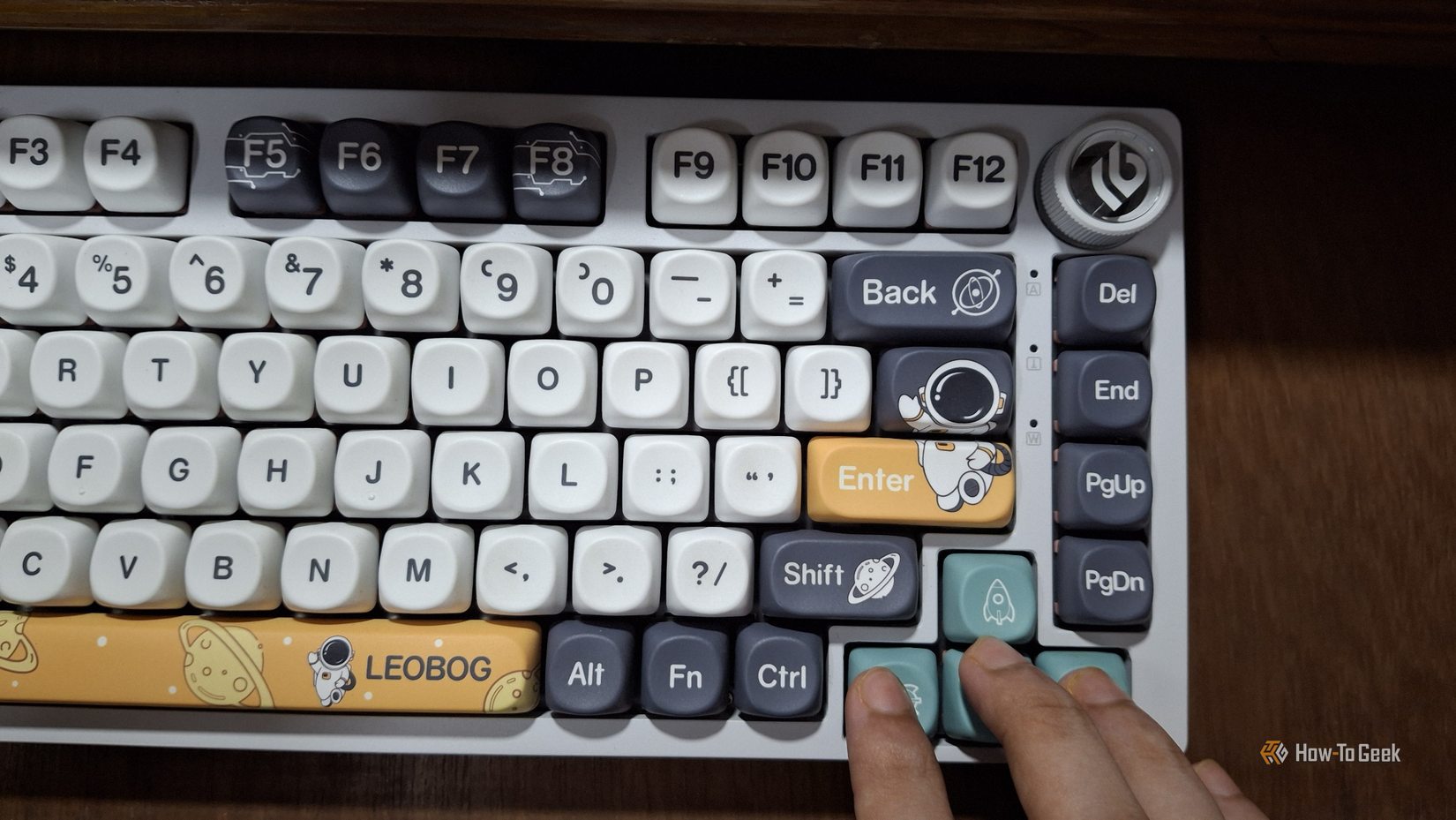 A keyboard being showcased with fingers on the arrow keys.
