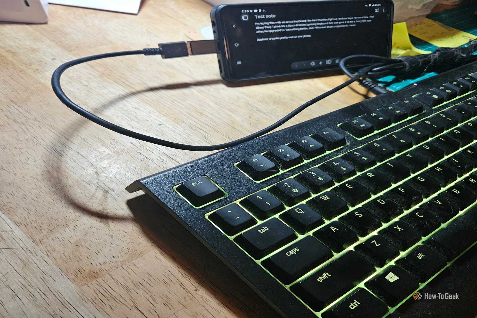 A blac keyboard attached to a Motorola phone.