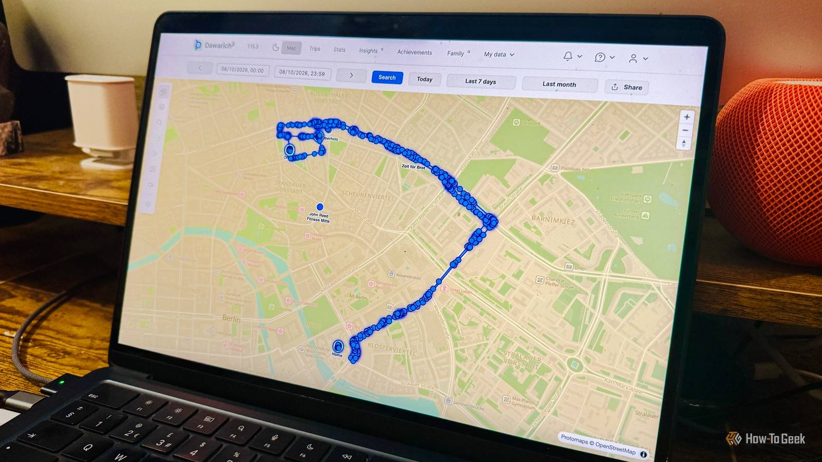 Laptop showing the Dawarich web interface with a days location history plotted as blue GPS points on a map of Berlin.