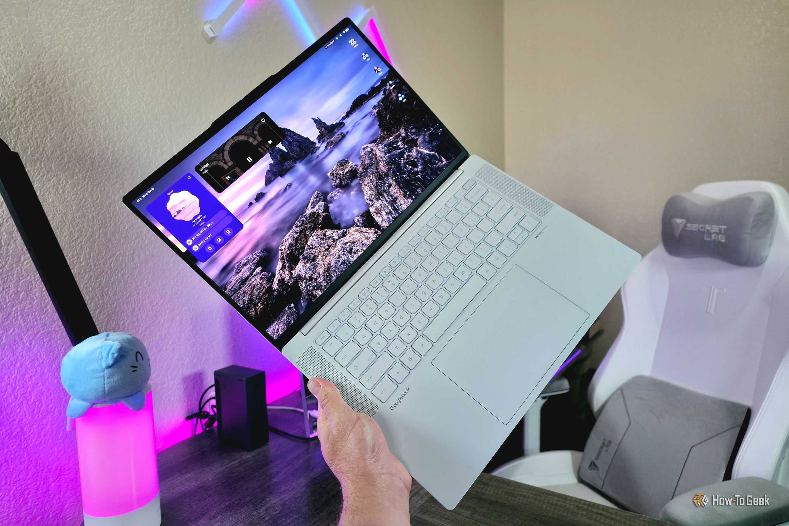 Image of the Lenovo Googlebook 15 while fully open and held in the hand.