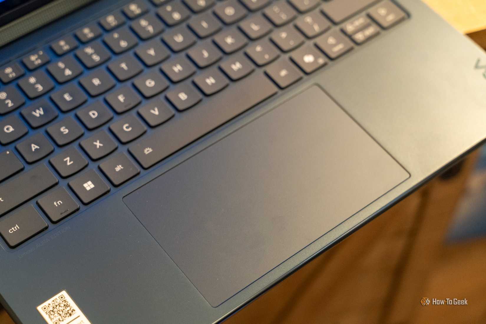 Close-up of the large trackpad and surrounding blue palm rest on the Lenovo Yoga 9i.