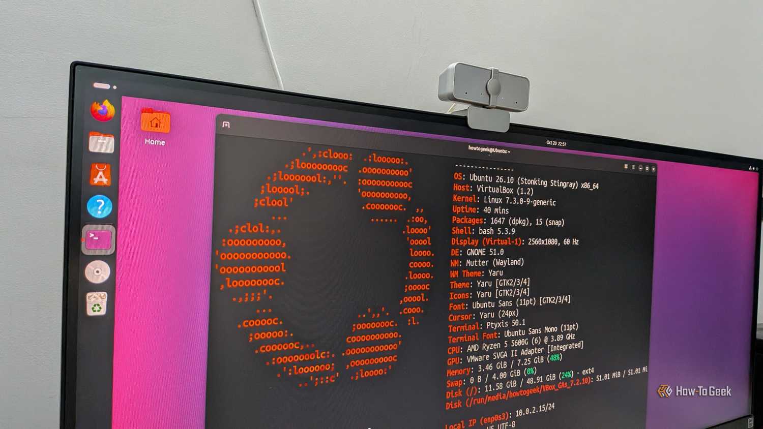 Monitor photo of Ubuntu 26.10 running fastfetch in a terminal, showing Linux kernel 7.3 and GNOME 51.