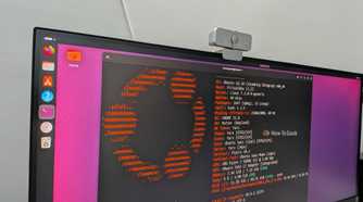 Monitor photo of Ubuntu 26.10 running fastfetch in a terminal, showing Linux kernel 7.3 and GNOME 51.