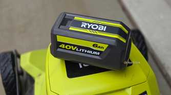 A Ryobi 40v battery on top of a bigger Ryobi machine with wheels.