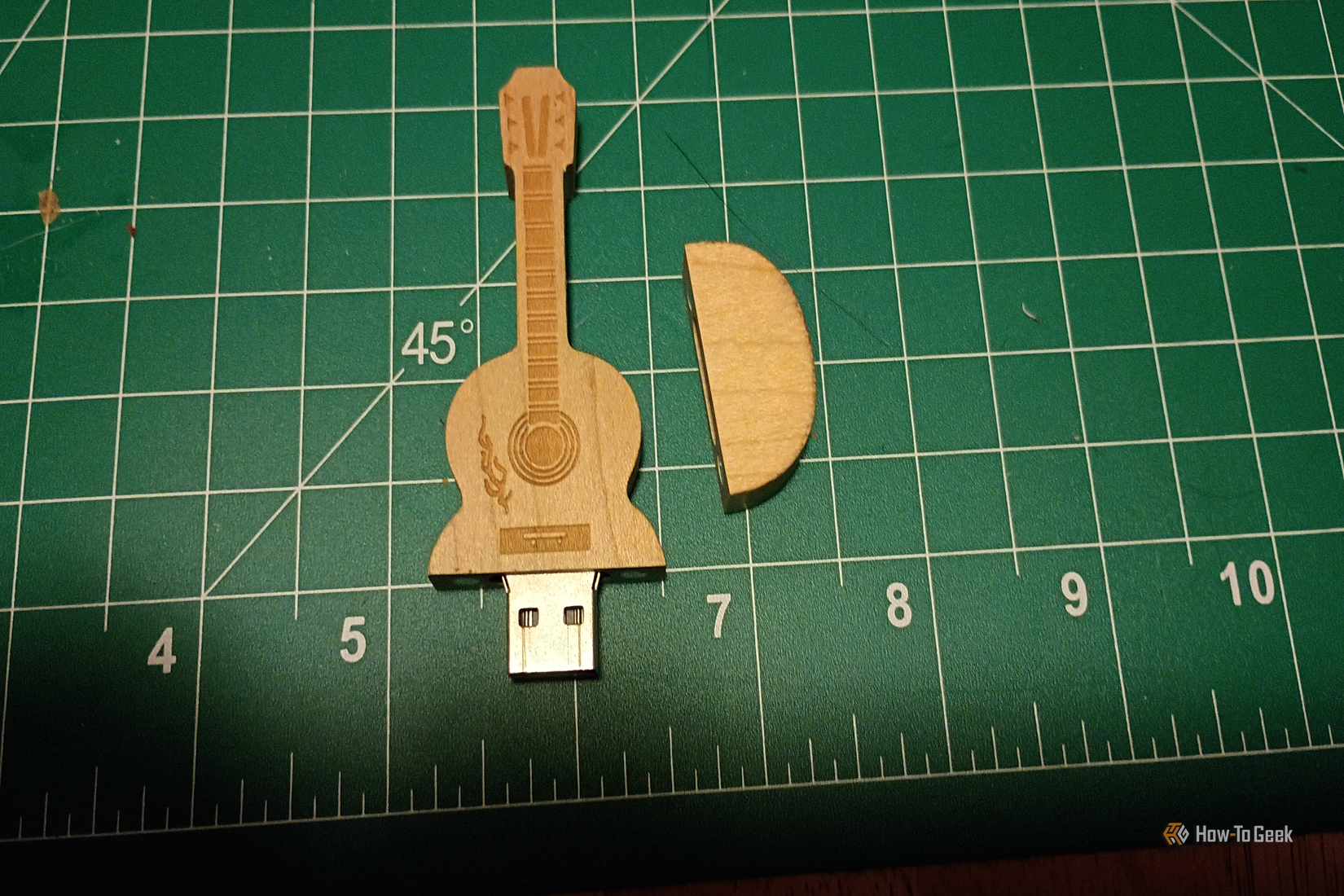 A guitar-shaped USB drive made of wood that one day wants to be a real USB stick.