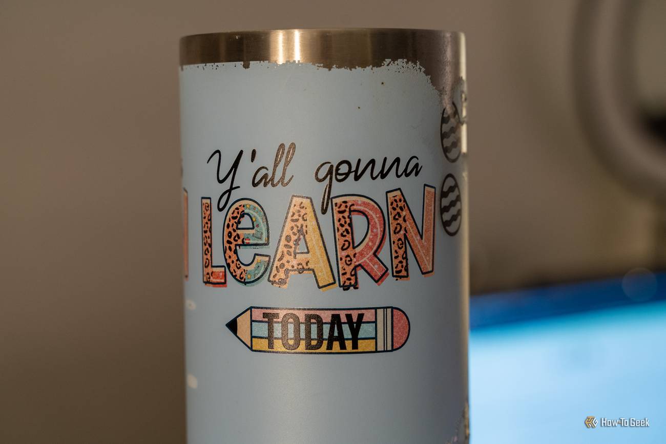 Close-up of a UV-printed tumbler with colorful lettering reading Y'all Gonna Learn Today and a pencil graphic.