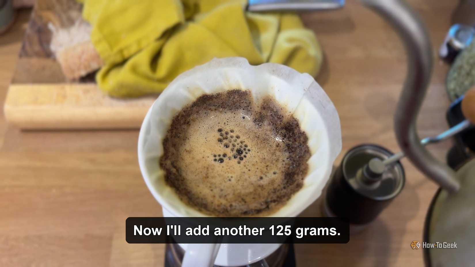 Water being poured over coffee grounds with automatically generated subtitles.