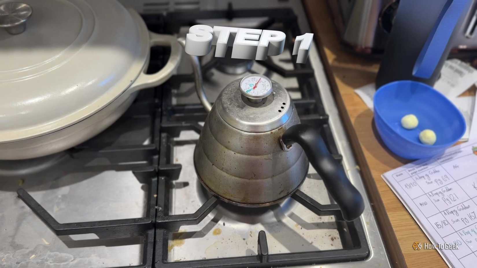 White 3D Step 1 text tracked above a kettle on a kitchen hob.